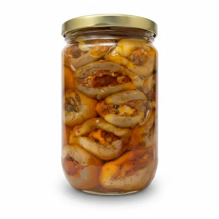 Side view showing jar filled with pickled aubergines stuffed with walnuts and spices