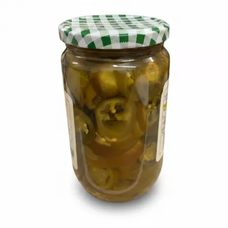 Side view of jar showing pickled jalapeño slices