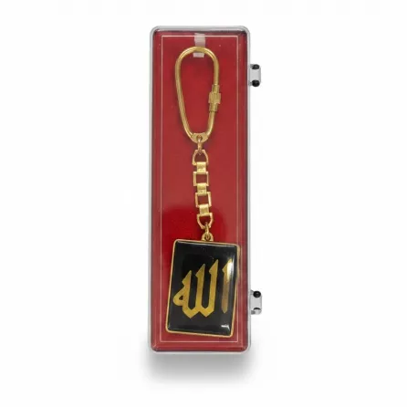 Gold-coloured keychain with Arabic calligraphy on black background in display box