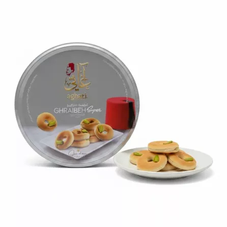 Aghati Ghraibeh Super pistachio cookies tin with cookies displayed on plate