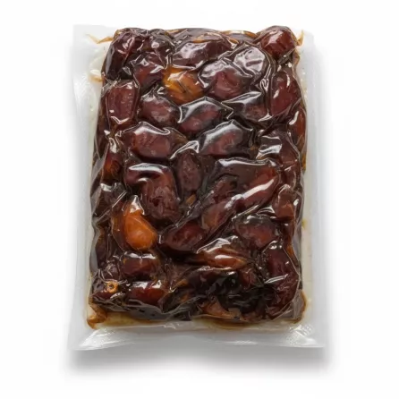 Close-up view of vacuum-sealed Saudi dates showing moist texture