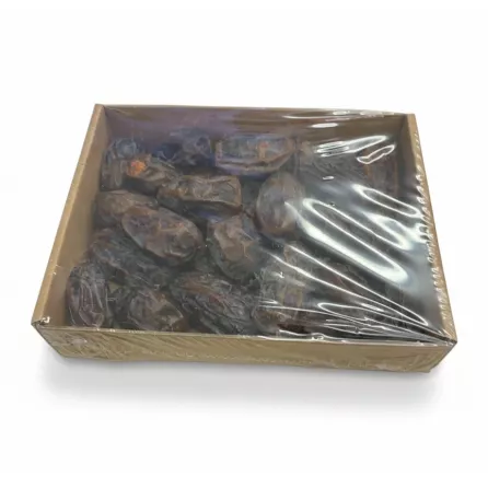 Close-up view of Medjool dates in transparent tray inside box