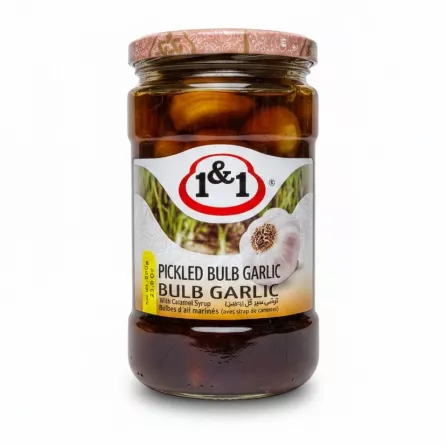 Jar of 1&1 Pickled Bulb Garlic with caramel syrup showing label