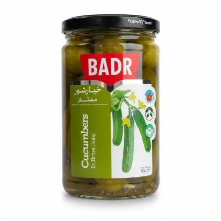 Glass jar of Badr baby cucumbers in brine showing front label