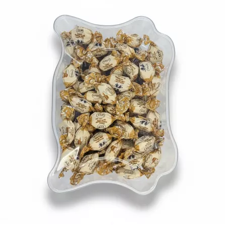 Top view of clear toffee container showing packed milk honey toffees