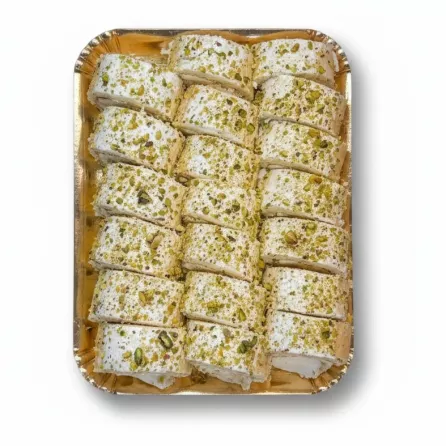 Tray of sliced pistachio cream rolls topped with chopped pistachios