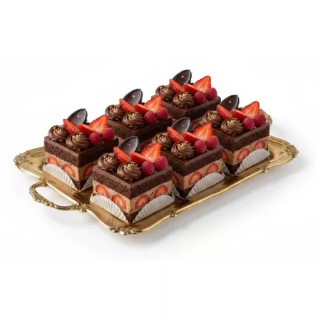Tray of multiple rich chocolate berry cake slices decorated with fresh fruits and chocolate