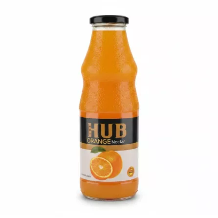 Glass bottle of The Hub Orange Nectar juice on wooden desk