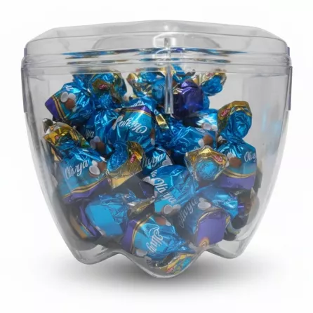 Transparent container full of individually wrapped assorted chocolates
