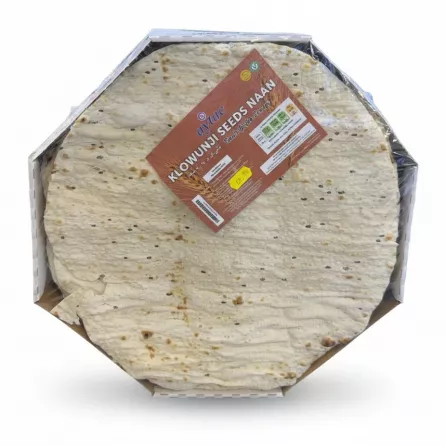 A stack of round flat breads with black seeds wrapped in plastic with a label