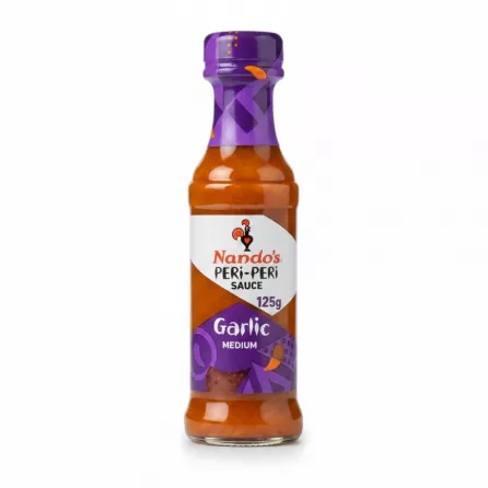 Bottle of Nando's Peri-Peri Garlic Medium Sauce with purple label