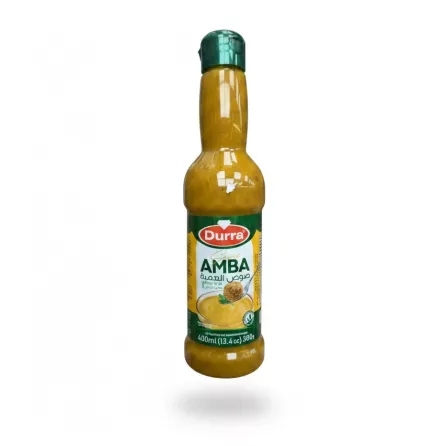 Bottle of Durra Amba sauce with green cap held in hand
