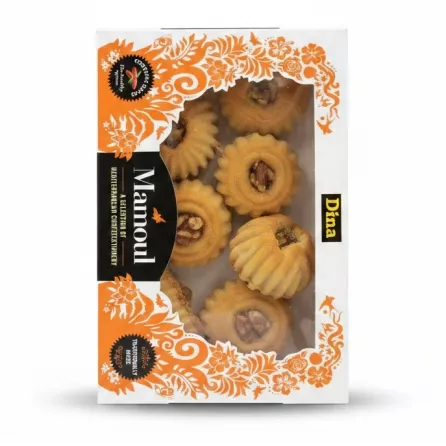 Box containing assorted Mamoul pastries with visible walnut, date and pistachio shapes