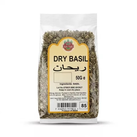 Enhanced Hand holding Safa Food Dry Basil 50g packet in a grocery store