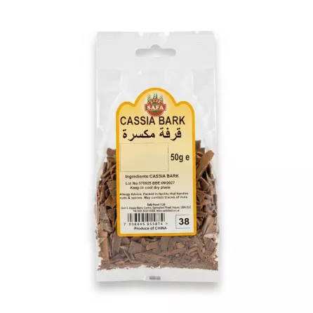 Enhanced A hand holding a packet of Safa Cassia Bark 50g with clear labelling and visible spice pieces inside.
