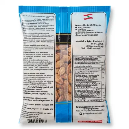 A clear product shot of the back of the Al Amira Red Melon Seeds bag, showing detailed ingredients and nutrition facts tables. The roasted melon seeds are visible through a central window on the clean white and blue packaging.