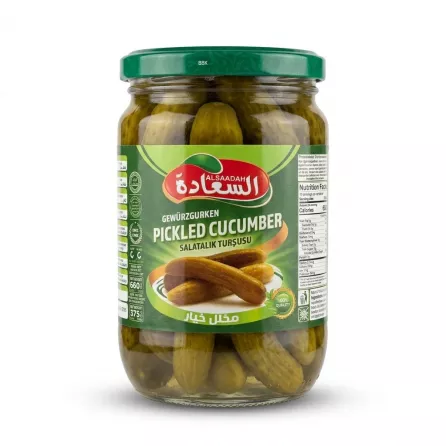 Enhanced Hand holding a jar of AlSaadah Pickled Cucumber 660g in a grocery aisle