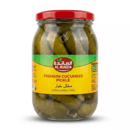 Al Maeda Premium Cucumber Pickle in a 1450g glass jar with a red lid. The jar is packed with whole pickled cucumbers and features a distinct yellow and green label with the brand logo in Arabic and English, centered against a clean white background.
