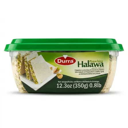 A 350g (12.3oz) clear plastic tub of Durra Pistachio Halawa, showing the product inside, the green lid, and the label with branding and weight details, against a white background.