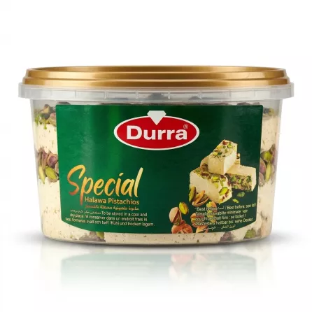Enhanced Hand holding a tub of Durra Special Halawa Pistachios in a shop