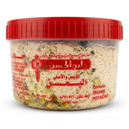 Enhanced Tub of Al Yaman Super Halawa Pistachio with red lid shown in hand