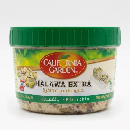 A 400g tub of California Garden Halawa Pistachio Extra, featuring a green lid and detailed packaging, centered on a clean white background with soft, symmetrical shadows. The labels are sharp and legible, showing the product name and a cluster of green pistachios.