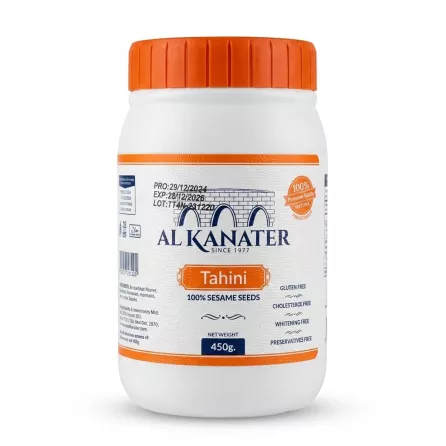 Enhanced Front of Al Kanater Tahini jar 450g in a person's hand