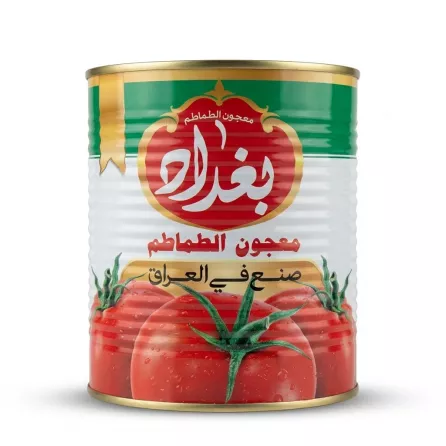 A 1:1 professional e-commerce product photograph of an 800g Baghdad Tomato Paste tin on a seamless white background. The clean, unblemished can is centered, with all factual Arabic text and graphics sharp and clear, depicting the authentic Halal Iraqi product under soft, studio lighting with even shadows. PRODUCT TITLE: Baghdad Tomato Paste Tin - Halal & Authentic 800g
