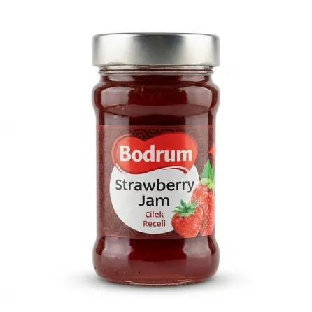 A high-resolution e-commerce photograph of a 380g jar of Bodrum Strawberry Jam with a silver lid, featuring a clean red and white label with Turkish and English text. The glass jar reveals a rich, dark red jam on a seamless white background with a subtle, soft shadow.