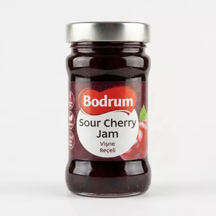 [A centered, professional studio photograph of a 380g jar of Bodrum Sour Cherry Jam against a plain white background. The jar is well-lit with soft, symmetrical shadows and features a clean label with text in English and Turkish.]