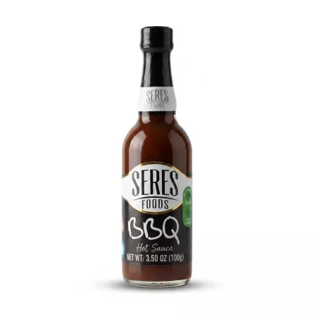 Enhanced Hand holding a bottle of Seres Foods BBQ Hot Sauce 100g