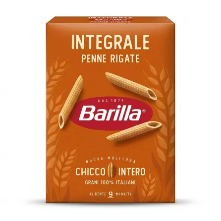 A professional 1:1 e-commerce product photograph of a 500g box of Barilla Wholemeal Penne Rigate pasta on a clean white background. The orange-brown box is centered and takes up 85% of the frame. It displays the text "INTEGRALE PENNE RIGATE" and "Barilla," along with illustrations of wheat and three dry penne pasta pieces. All text and graphics are sharp and clear.