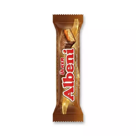 Enhanced Hand holding an Ülker Albeni Chocolate Caramel Bar in a shop