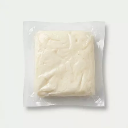 Enhanced Unwrapped Dairy Day halloumi cheese piece in vacuum-sealed pack