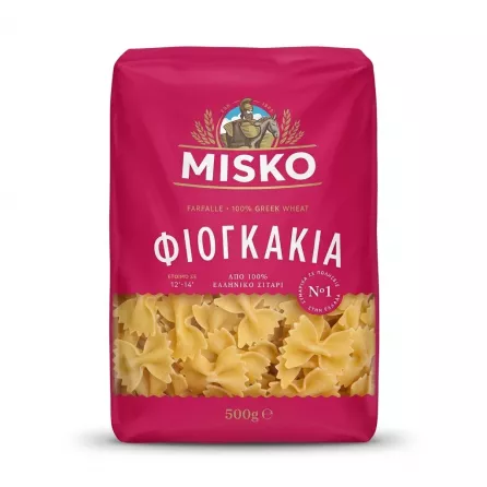 A 1:1 professional e-commerce product photograph showing a single 500g package of Misko Farfalle pasta against a clean, white background. The bright magenta package is centered, featuring clear Greek and English text, with a transparent window at the bottom revealing the bow-tie-shaped pasta. There are no tags or labels, and the lighting is even and sharp with a soft, symmetrical shadow.