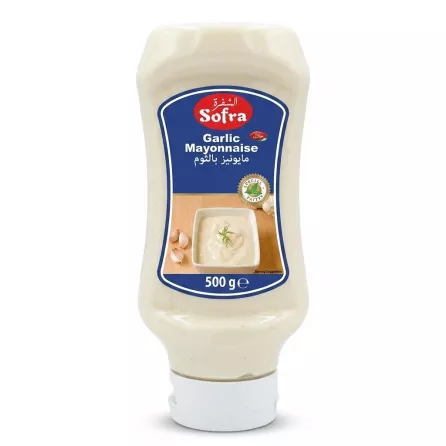 A 1:1 professional studio photograph of a Sofra Garlic Mayonnaise 500g squeeze bottle, isolated on a pure white background with soft, symmetrical shadows. The detailed blue front label, containing all original English and Arabic text, the logo, the serving suggestion image, and weight info, is sharply defined. {image}