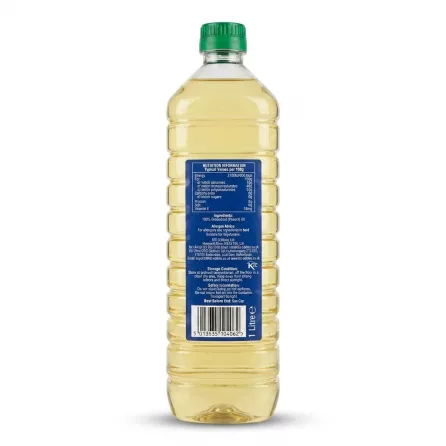 A 1-litre clear plastic bottle of KTC Pure Groundnut Oil stands centered against a seamless white background, displaying its back label. The blue label features detailed nutritional information, ingredients list, and a crisp barcode at the bottom, all clearly legible under sharp studio lighting.