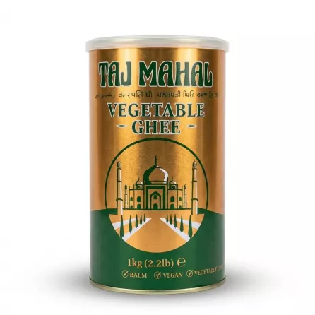 A professional product photo showing the 1kg tin of Taj Mahal Vegetable Ghee. It features a gold and green design with an illustration of the Taj Mahal, centered on a pure white background with soft, symmetrical shadows.