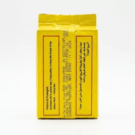 A professional, close-up photograph of the back of an El Arosa Black Kenyan Tea loose leaf 100g yellow foil pack. The product information, including English and Arabic text, and production details, are clearly displayed under perfect studio lighting.