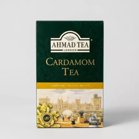 Enhanced Hand holding Ahmad Tea Cardamom Tea 500g box in front of tea shelf