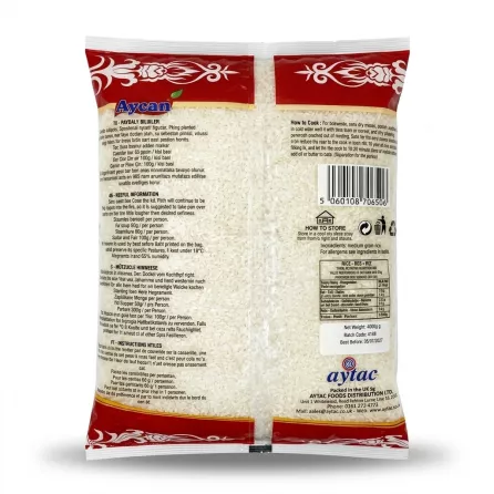 A clear, professional, centered product shot on a pure white background shows the back of a large Aycan Tosya Medium Grain Rice bag. The image details the white rice texture inside the clear bag, surrounded by red and white branding, cooking instructions, nutritional information, and barcode. The bag is scaled to fill the frame and is lit with soft studio lighting, creating symmetrical shadows.