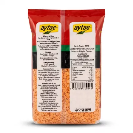 A 1:1 professional e-commerce product photograph showing the detailed back label of a 1kg pack of Aytac Red Lentils Split against a clean, white background. The central label displays comprehensive information, including a precise Nutritional Analysis per 100g, full ingredient listing of split red lentils, allergy advice (may contain traces of wheat, soya, barley, spelt), detailed customer care contact details for Aytac Foods Distribution Limited, address info, the barcode, batch code 6030, and best before date 30/01/2029. The lower portion of the clear packaging window reveals the texture and vibrant color of the split red lentils inside. The lighting is studio-quality and even, ensuring all text is sharp and legible, with a soft, symmetrical shadow below the centered product which fills 85% of the frame.