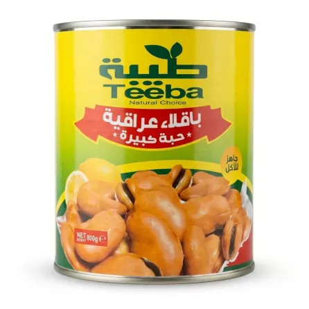 A 1:1 professional e-commerce product photo of an 800g Teeba Natural Choice Large Fava Beans tin against a solid white background, with all background elements and hands removed. The yellow can label features Arabic and English text, a banner, and an illustration of fava beans with lemon slices.