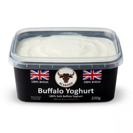 A 1:1 professional studio photo of Alsadda Buffalo Yoghurt, showing the black rectangular tub filled with thick white yoghurt under a clear lid, perfectly centered on a seamless white background. The clean labels with a Union Jack, Alsadda logo, and '100% British' text are clearly visible.