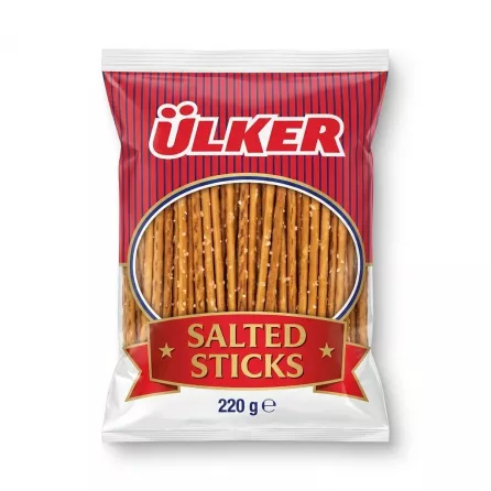A 220g pack of Ülker Salted Sticks snack is shown in a professional, front-facing e-commerce photo with clean, even lighting and a soft shadow on both sides. The red and blue packaging features the distinct Ülker logo and a clear window displaying the salted pretzel sticks inside.