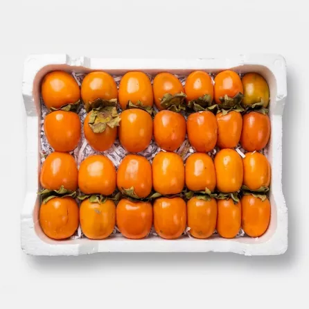 Enhanced Box of vibrant orange Lebanese Kaki persimmons on display