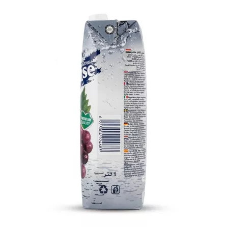 A clear, close-up photograph of the side and partial front of an Everyday Paradise Grape Juice 1L carton, showing a detailed multilingual ingredients list and a barcode. The Halal Certified logo and the product's premium quality branding are visible on the clean, white packaging.