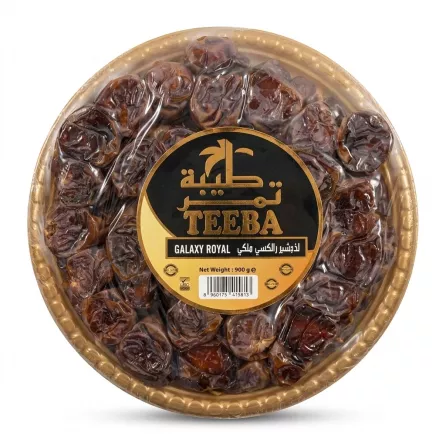 A 900g tray of Teeba Galaxy Royal Saudi Dates, a round plastic platter containing dark brown dried dates with a black and gold central label.