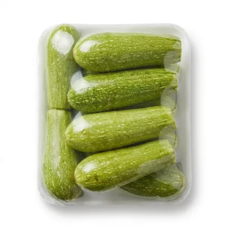 A clear plastic-wrapped package of Lebanese Green Courgettes (Zucchini), with approximately eight individual pieces visible, is shown centered on a clean white background. The courgettes are light green and fresh-looking, arranged neatly inside the packaging.