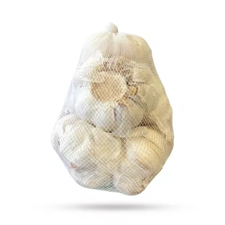 Enhanced Hand holding a mesh bag of Bravo Fresh Garlic in a store